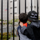 Javier Tapia (left), age 5, and his brother, Charlie Tapia, age 7, from Seattle, look at a Federal Detention Center holding migrant women on June 9, 2018 in SeaTac, Washington. The boys, whose family is originally from Mexico, were here as part of a protest.